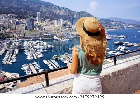 Holidays in Monaco. Beautiful woman in Monte-Carlo looking cityscape with skyscrapers and harbor in the Principality of Monaco. Luxury resort vacation concept.