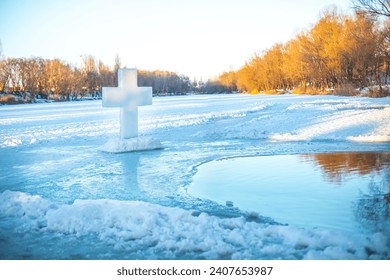 Holidays of Orthodox baptism. Ice cross hole and a cross of ice in Ukraine