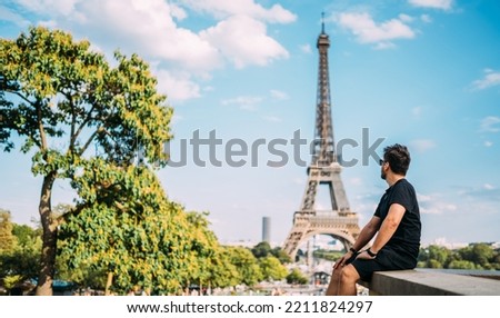 Holidays in Paris. Man enjoying Paris, France. Summer vacation in Europe. Eiffel Tower.