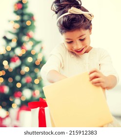 Holidays, Presents, Christmas, X-mas Concept - Happy Child Girl With Gift Box