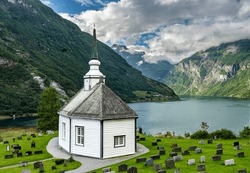 Holidays In Southern Norway: The Epic Geiranger Fjord - The Beautiful Old Church Of Geiranger With Cemetery And Views Of The Fjord