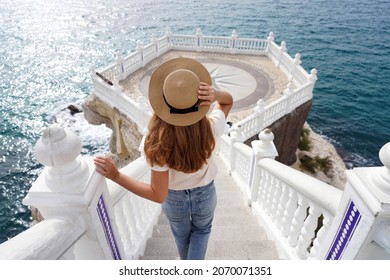 Holidays In Spain. Back View Of Young Traveler Woman Descends Stairs Towards The Mediterranean Balcony In Benidorm, Alicante, Spain.