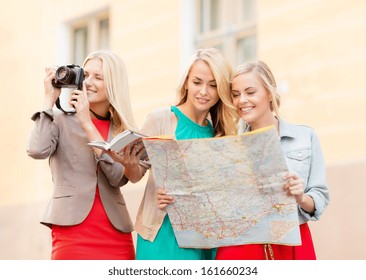 Holidays And Tourism Concept - Beautiful Blonde Women With Tourist Map And Photo Camera In The City