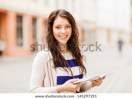 Similar – Image, Stock Photo Young woman and French bulldog on tree trunk at the beach