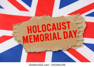 Holidays Of The UK. Against The Background Of The Flag Of Great Britain Lies Cardboard With The Inscription - Holocaust Memorial Day