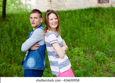 holidays, vacation, love and friendship concept - smiling teen couple young cheerful hipster Best Friends boy and girl having fun, played outdoors, mimic fight, positive emotions, back to back