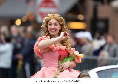 Holland, Michigan, USA - May 11, 2019: Tulip Time Parade, Woman dress up as Disney Character Aurora during the parade