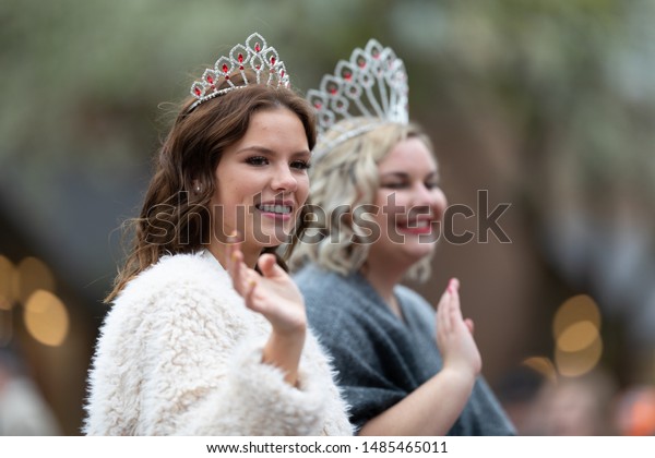 Holland, Michigan, USA - May\
11, 2019: Tulip Time Parade, Beauty queens, smiling and waving at\
the spectators, being transported on the back of a car during the\
parade