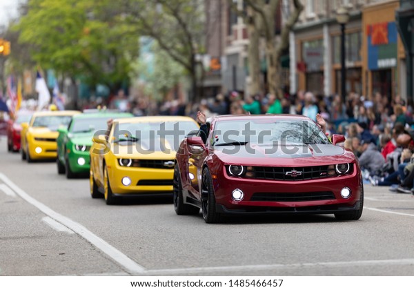 Holland, Michigan,\
USA - May 11, 2019: Tulip Time Parade, A group of Camaros going\
down the road during the\
parade