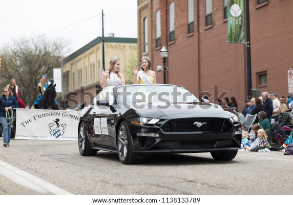 Holland, Michigan, USA - May 12, 2018 Miss\
Mattawan riding on a car down the road at the Muziek Parade, during\
the Tulip Time\
Festival