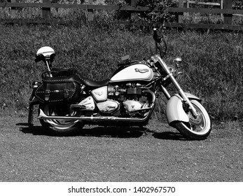 Hollingwood, Derbyshire, UK; 15/05/2019: A Monochrome Illustrative Image Of A Triumph Custom Motorcycle With A Crash Helmet On Sissy Bar And Leather Panniers.