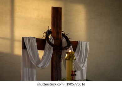 holly cross and candle, whit the Jesuschrist crown of thorns, simbols for celebration of the easter