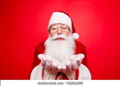 Holly jolly x mas festive occasion noel time! Santa in headwear, costume, white gloves expresses winter wish, surprise, fantasy, blizzard, snow, snowflakes, air kiss - Powered by Shutterstock