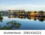 Hollywood beach in Miami, Florida with Intracoastal water canal Stranahan river and view of waterfront property modern mansions villas houses with palm trees reflection at sunset