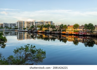 Hollywood beach in Miami, Florida with Intracoastal water canal Stranahan river and view of waterfront property modern mansions villas houses with palm trees reflection at sunset