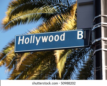 Hollywood Blvd Street Sign With Tall Palm Trees.