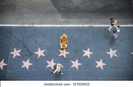 HOLLYWOOD, CA - OCTOBER 12, 2016: People visit Walk of Fame in Hollywood. Hollywood Walk of Fame features more than 2,500 stars with inscribed celebrity names.