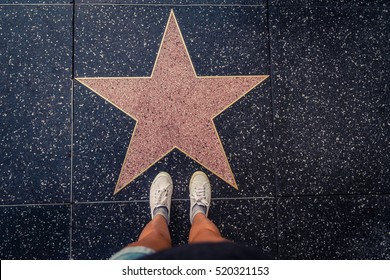 HOLLYWOOD, CA - OCTOBER 12, 2016:.Tourist photographing her with an empty star on the Walk of Fame in Hollywood. Hollywood Walk of Fame features more than 2,500 stars with inscribed celebrity names