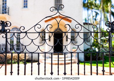 Hollywood, Florida in Broward County city in North Miami Beach area with entrance metal gate fence and background of luxury house mansion near the beach