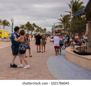 Hollywood, Florida - January 10, 2018: Tourists Dancing On Boardwalk In Hollywood Florida With Palm Trees In Background