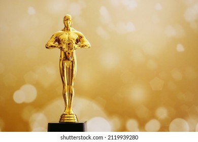 Hollywood Golden award statue on fireworks background. Success and victory concept.