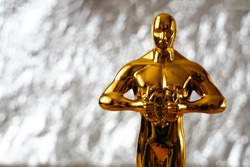 Hollywood Golden Oscar Academy Award Statue On Silver Background With Copy Space. Success And Victory Concept.