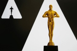 Hollywood Golden Oscar Academy Award Statue On White And Black. Success And Victory Concept.