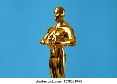  Hollywood Golden Oscar Academy award statue on blue background. Success and victory concept.