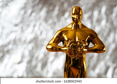 Hollywood Golden Oscar Academy Award Statue On Silver Background With Copy Space. Success And Victory Concept.