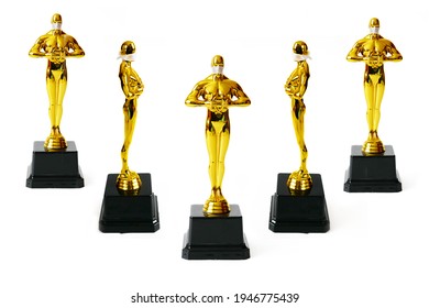Hollywood Golden Oscar Academy award statue in medical mask isolated on white background. Set. Success and victory concept. Oscar ceremony in coronavirus time