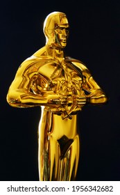 Hollywood Golden Oscar Academy award statue on black background. Vertical view. Success and victory concept.