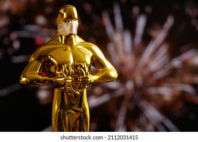 Hollywood Golden Oscar Academy award statue on fireworks background with copy space. Success and victory concept.