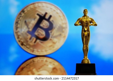 Hollywood Golden Oscar Academy award statue on golden bitcoin background. Success and victory concept.