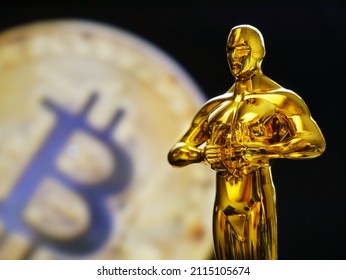 Hollywood Golden Oscar Academy award statue on golden bitcoin background. Success and victory concept.