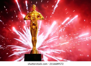 Hollywood Golden Oscar Academy award statue on fireworks background. Success and victory concept.