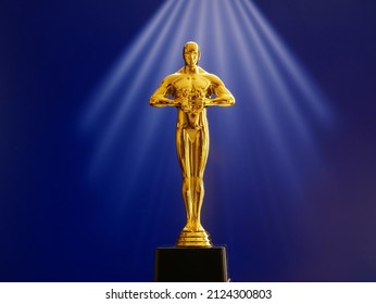 Hollywood Golden Oscar Academy award statue on red background. Success and victory concept. - Shutterstock ID 2124300803