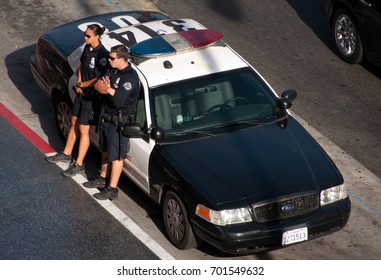 Hollywood, Los Angeles, California, USA - June 14, 2014: US Police Officer On Duty At The Police Car