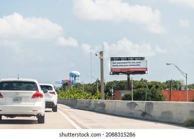 Hollywood, USA - July 8, 2021: Interstate Highway I95 In Miami With Billboard Sign For Get Vaccinated For Covid-19 Coronavirus By Curative Company And Cars In Traffic