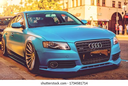 Hollywood, Year 2016: front view of a custom Audi A4 Quattro. Auto aleman wrapped, matte light blue paper. Plotted body, low suspension. Custom sedan parked on Hollywood Blvd.