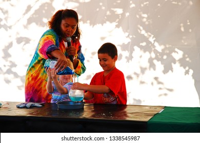 Holmdel, NJ, USA October 10 A Young Boy And Woman Participate In A Science Experiment At A State Fair In Holmdel, New Jersey