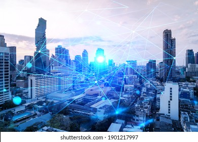 Hologram of abstract technology glowing icons, panoramic cityscape of Bangkok at sunset, Asia. The concept of worlds technological changes. Double exposure.