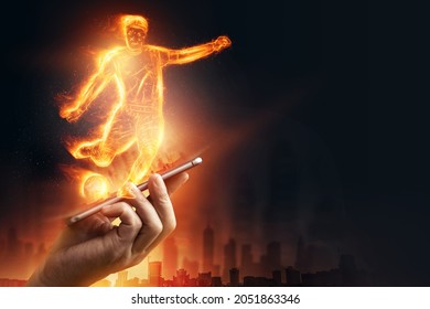 A hologram of a football player running out of a smartphone screen. The concept of sports betting, football, gambling, online broadcast of football - Powered by Shutterstock