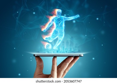 A hologram of a football player running out of a smartphone screen. The concept of sports betting, football, gambling, online broadcast of football - Powered by Shutterstock