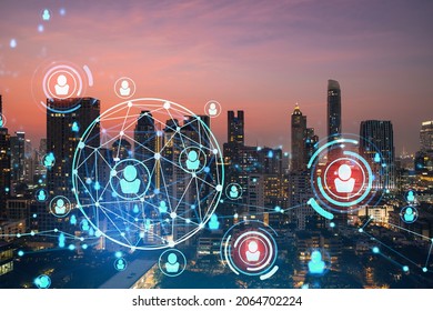 Hologram of social media icons over sunset panoramic cityscape of Bangkok, Southeast Asia. The concept of people connections and career opportunities. Multi exposure.