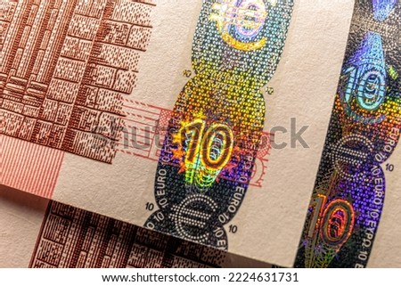 Hologram tamper-proof currency seal authenticity watermark of ten euro banknote macro.
