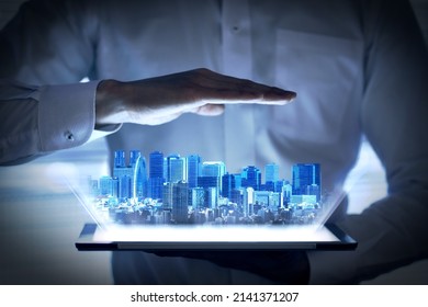 Holographic Image Of Urban Development That Emerges From The Tablet