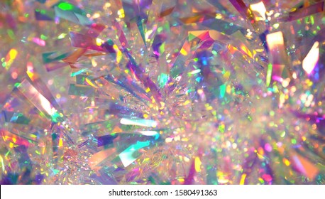 Holographic iridescent tinsel. Hologram Background of abstract shiny foil texture with rainbow colors. Neon pastel gradient of real surface - Powered by Shutterstock