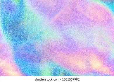 Holographic real texture in blue pink green colors with scratches and irregularities. Holographic color wrinkled foil. Holographic rainbow foil abstract background. - Shutterstock ID 1051557992