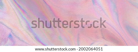 Holography real cloth texture in blue pink colors. Banner. Holographic neon color wrinkled pearlescent foil. Holographic iridescent rainbow fabric abstract background.