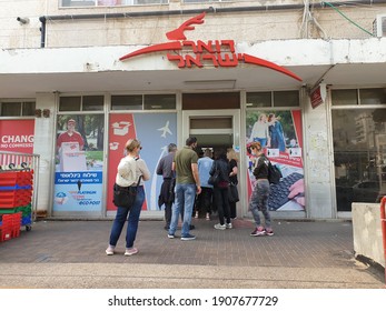 HOLON, ISRAEL. February 2, 2021. A Long Line Of People Waiting Outside A Local Post Office Due To Limited Number Of People Inside Allowed. Israel Post During The Pandemic Quarantine.